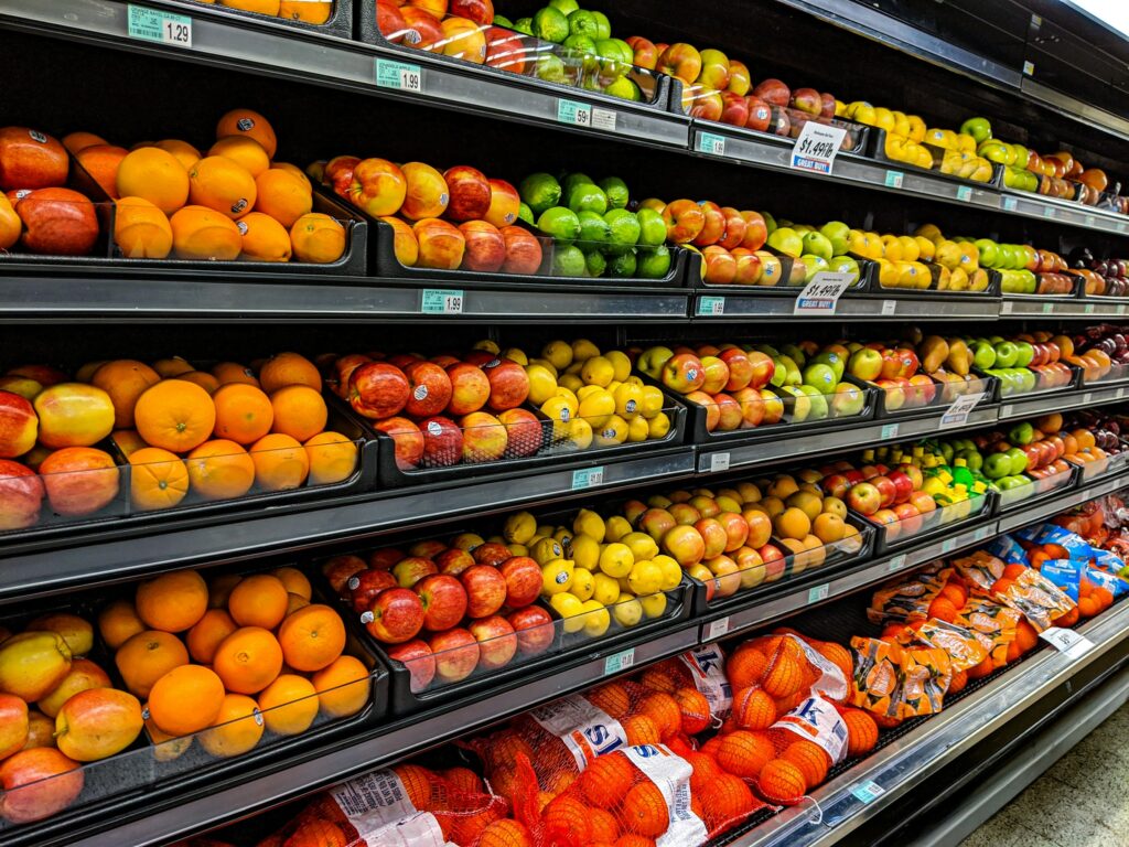 Apples, oranges, and lemons on a grocery store shelf